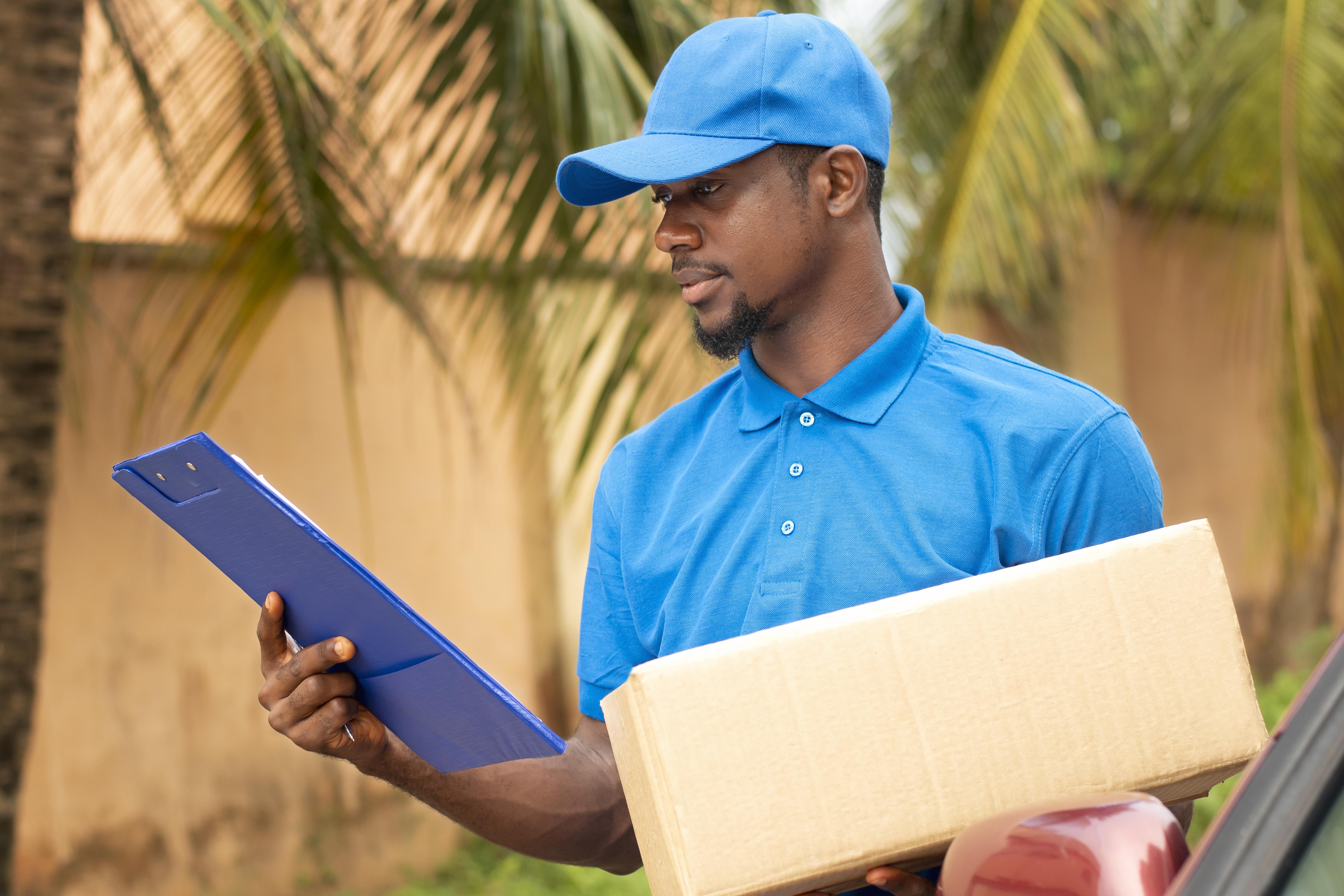 Close-up of a delivery person holding a parcel